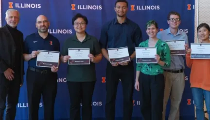 People holding certificates smiling
